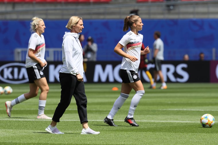 Germany head coach Martina Voss-Tecklenburg follow her players during the warm up prior to the start of the Women's World Cup Group B soccer match between Germany and China, at the Roazhon Park stadium, in Rennes, France, Saturday, June 8, 2019. (AP Photo/David Vincent)