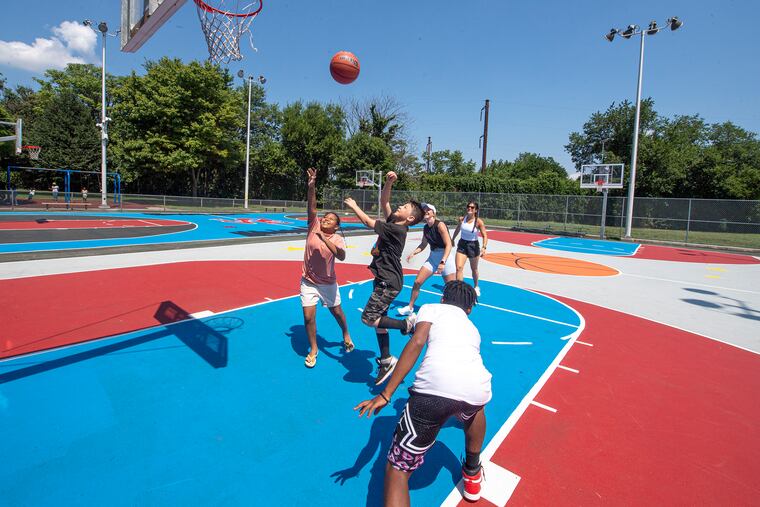 Kids play basketball on the new courts at the Hank Gathers Rec. Center in Philadelphia, Pa. Wednesday, July 20, 2022.