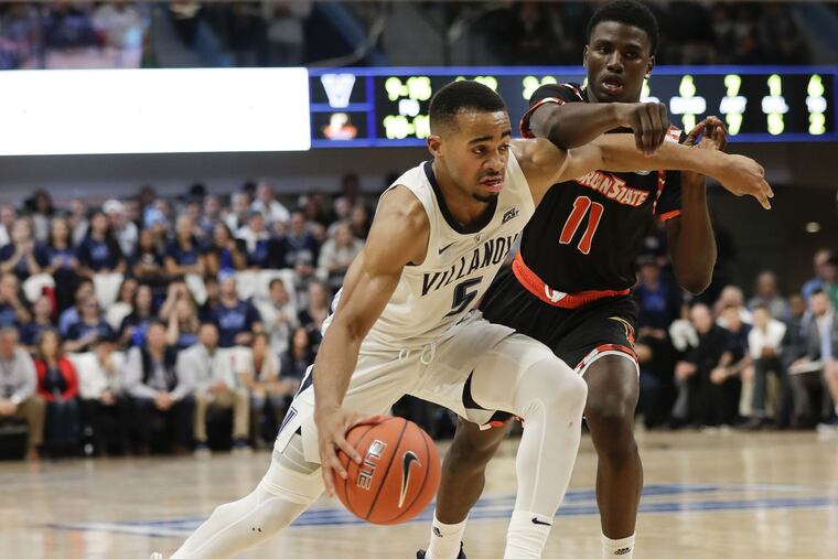 Villanova guard Phil Booth dribbles the basketball against Morgan State guard Malik Miller during the first-half at the Finneran Pavilion on Tuesday, November 6, 2018.