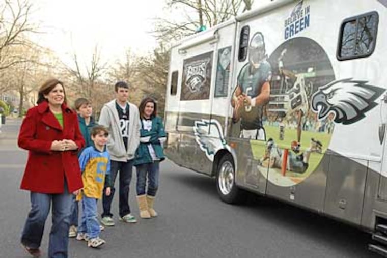 Monica Moeller (left) and children Sam, Paddy, Max and Emily greet their Eagles van as dad Patrick Moeller arrives home from work in Moorestown. (Sharon Gekoski-Kimmel / Staff Photographer)