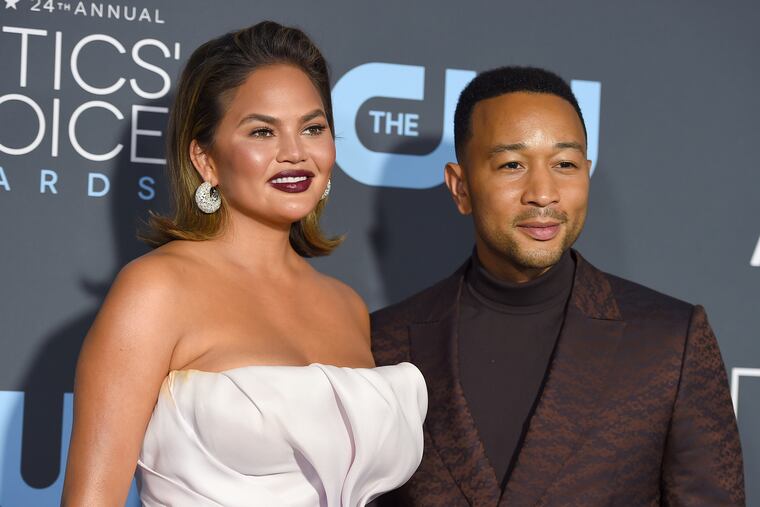 FILE - In this Jan. 13, 2019 file photo, Chrissy Teigen, left, and John Legend arrive at the 24th annual Critics' Choice Awards at the Barker Hangar in Santa Monica, Calif. President Donald Trump targeted the couple following an MSNBC special on criminal justice reform which Legend appeared on. In a series of tweets late Sunday, Sept. 8 and early Monday, Sept. 9 Trump felt he wasn’t getting credit for a law he signed in late December that, among other things, reduces mandatory minimum sentences in some cases. Trump called Legend “boring” and said Teigen was “filthy mouthed.” He criticized them for not playing a role in the reform. (Photo by Jordan Strauss/Invision/AP, File)