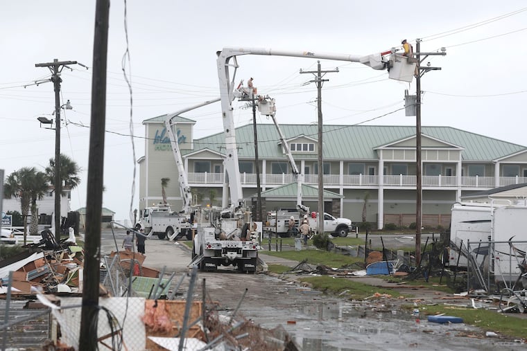Electric company linemen work to restore power after a tornado hit Emerald Isle, N.C., as Hurricane Dorian moved up the East Coast on Thursday.