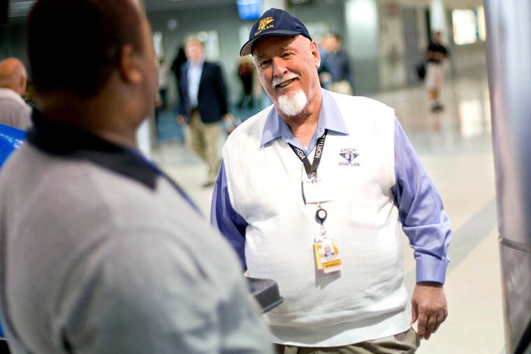 The Rev. Frank Colladay Jr., right, talks with airport worker Lance Norris as he makes his rounds through a concourse at Hartsfield-Jackson International Airport, in Atlanta.