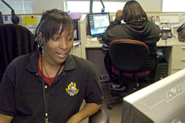Marjorie Mosley, a representative at Baltimore City's 311 non-emergency call center, assists a citizen caller. (Colby Ware/Special to the Inquirer)