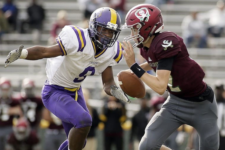 Camden’s Eli Sloan-El puts pressure on Cedar Creek QB Chris Snuffer.