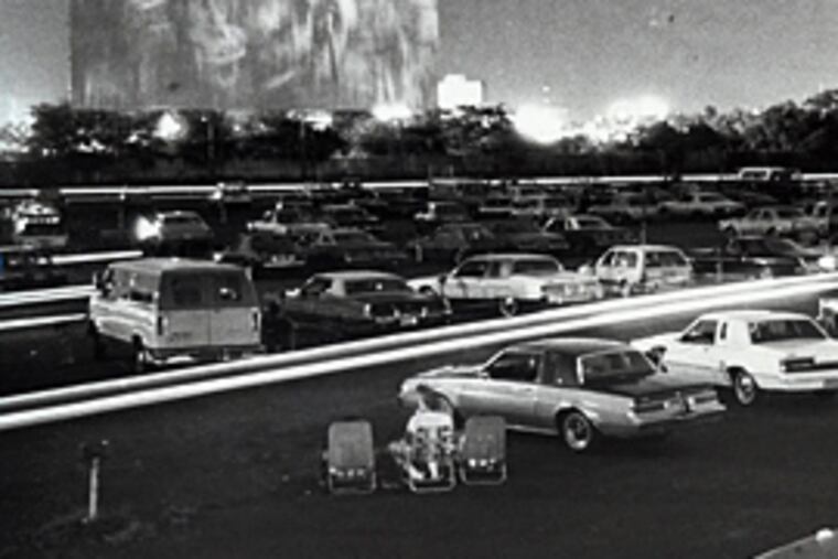 Patrons of the Tacony-Palmyra Drive-In Theater settle in their cars for a night's entertainment in August 1985. Little did they know there were scores of unexploded artillery shells under the parking lot. (David Jackson/Inquirer file)