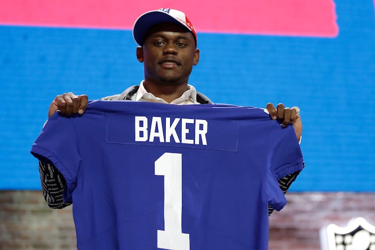 DeAndre Baker holds up his jersey after being selected 30th overall by the New York Giants in the first-round of the 2019 NFL draft. The 22-year old defensive back turned himself into police Saturday facing armed robbery charges.