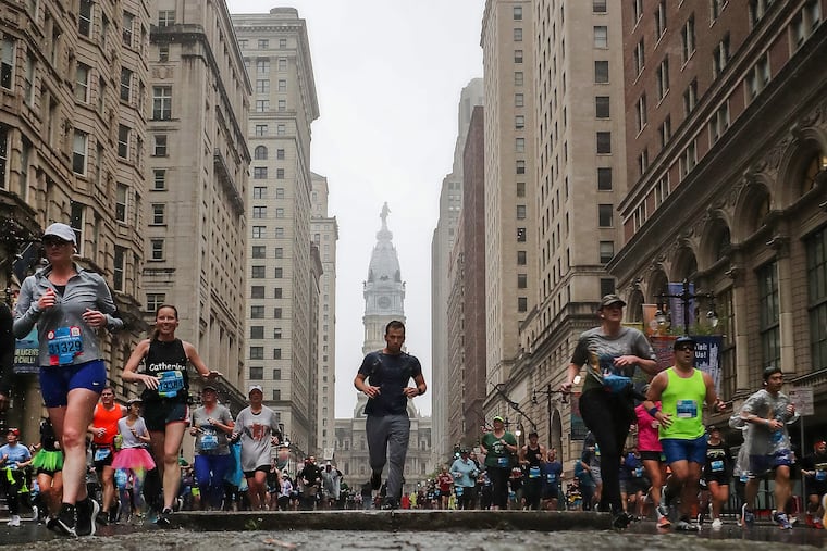 Runners pass Walnut Street during the 43rd annual Independence Blue Cross Broad Street Run in April 2023.