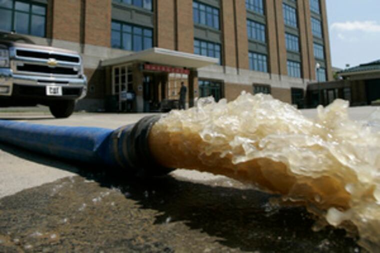 The Columbus (Ind.) Regional Hospital pumps floodwater out. More than 250 patients and employees had to be evacuated from the hospital yesterday.