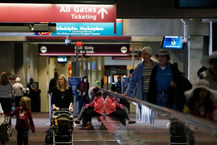 People face delays as they try to fly out of Philadelphia International airport on Monday, Dec. 23, 2013. ( RON CORTES / Staff Photographer )