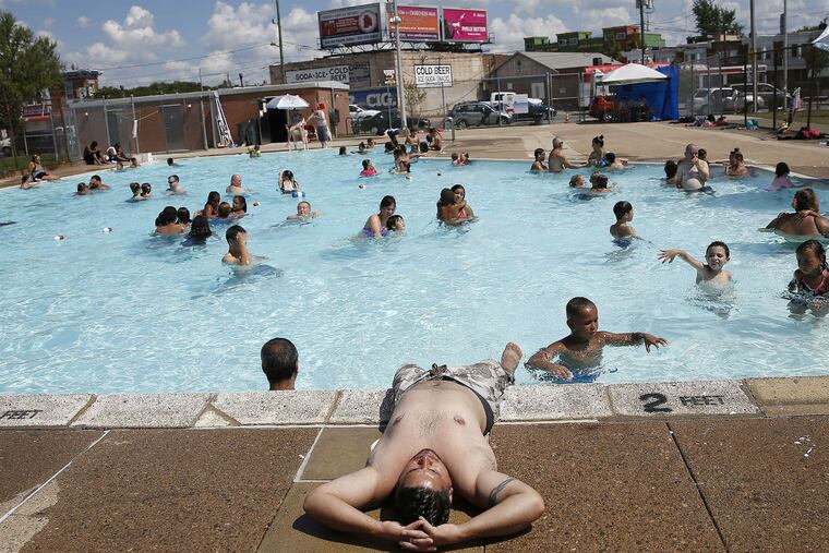 David Rodriguez, of North Philadelphia, relaxes at the edge of Cione Pool as his children splash nearby. A break in the heat is not expected before Monday, and even then, the high will remain in the 90s.