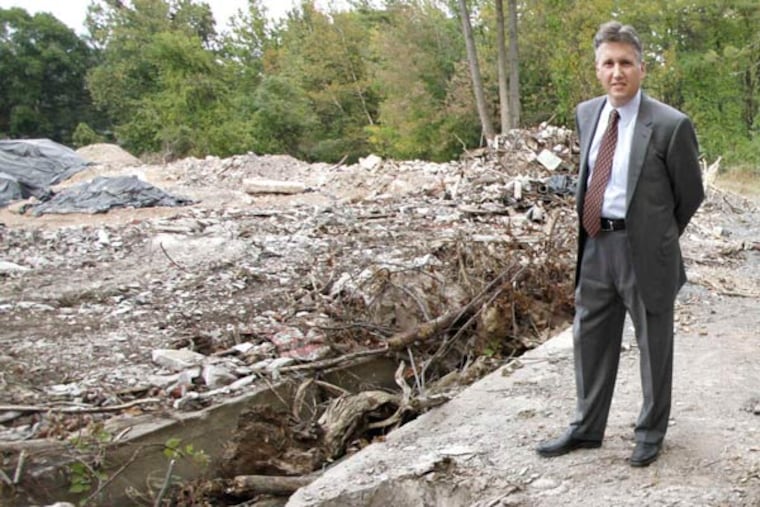 John Evans of Orleans Homebuilders Inc. walks the 30-acre site of the former Cold Spring Beverages in Yardley, which will become an upscale townhouse community.