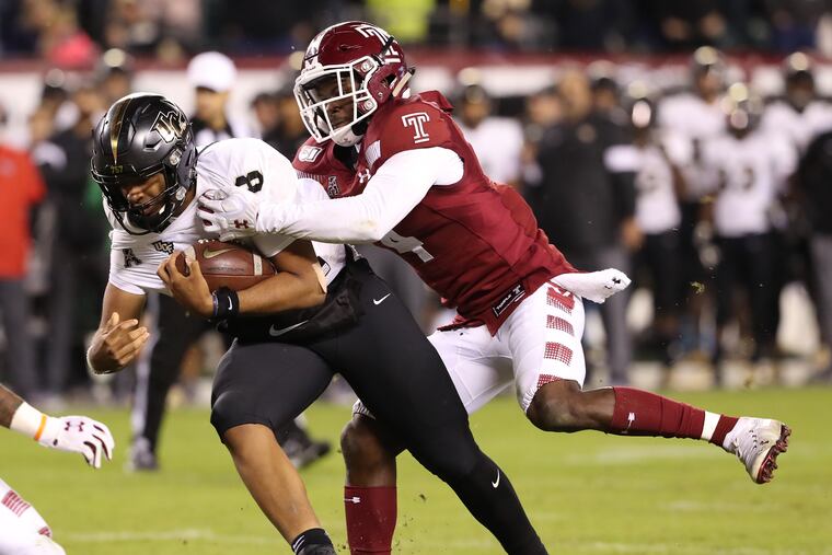 Darriel Mack, left, of Central Florida is tackled by Sam Franklin of Temple in the 4th quarter at Lincoln Financial Field on Oct. 26, 2019.