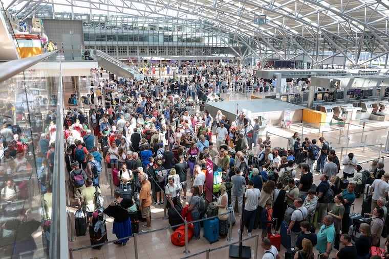 Travelers wait in Terminal 1 for check-in at Hamburg Airport, in Hamburg, Germany, on Friday, July 19, 2024. A widespread Microsoft outage disrupted flights, banks, media outlets and companies around the world.