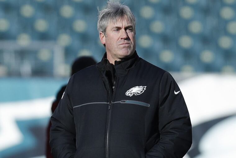 Philadelphia Eagles head coach Doug Pederson watches his team warm up before Saturday’s playoff game against the Atlanta Falcons at Lincoln Financial Field.