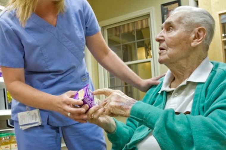 Tracy Kelly, nurse manager at Holy Redeemer Lafayette, talks with resident Michael Sheplock, 95, who has diabetes. (DAVID M WARREN / Staff Photographer)