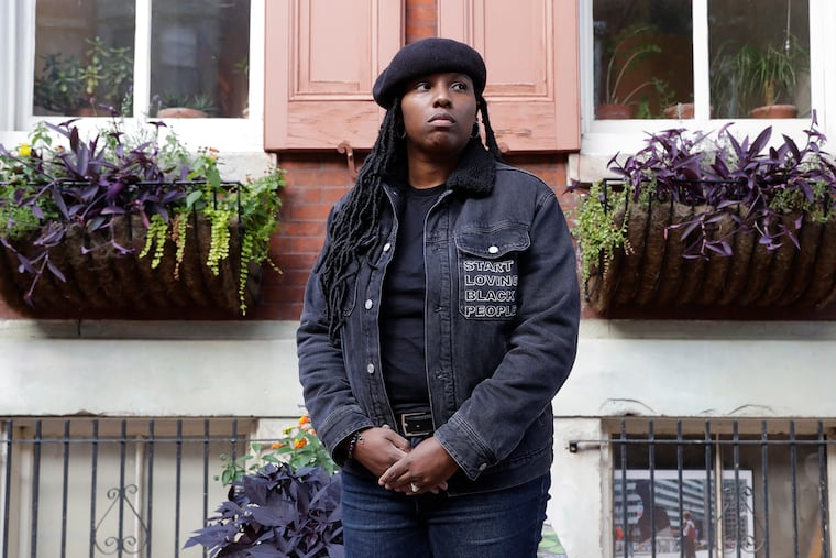 Philadelphia artist Mary Enoch Elizabeth Baxter stands in front of Thomas Eakins' Spring Garden neighborhood house on Monday, October 18, 2021.