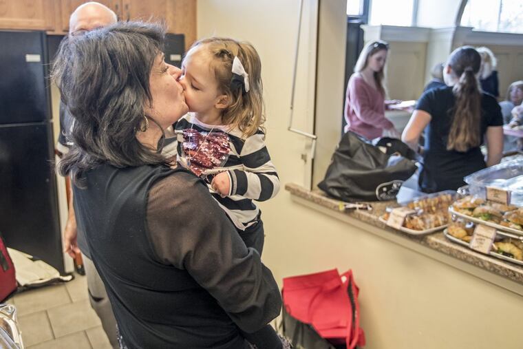 Gianna Masciantonio, 3, who has miraculously survived a life-threatening blood disease since birth, gives her grandmother, Andrea Masciantonio, a big kiss in the kitchen of St. Cyril of Jerusalem Church in Jamison, Bucks County, during her parents’ fundraiser for pediatric brain tumor research.