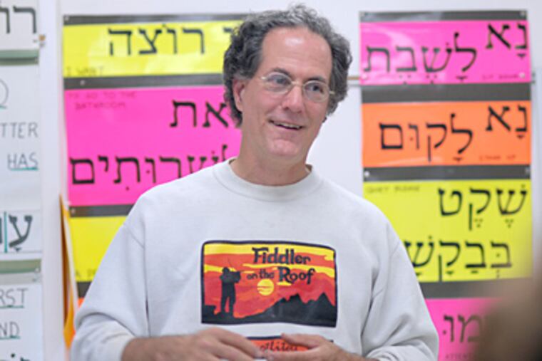 At Temple Emanuel in Cherry Hill, N.J., Ken Van Dyke teaches sixth-graders about the Jewish holy day of Yom Kippur. ( April Saul / Staff Photographer )