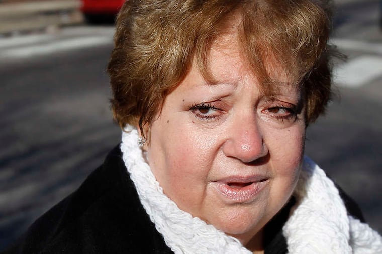 Midge Enrico-Carouso, a Catholic school substitute teacher, talks of the closings after Mass yesterday. (David Maialetti/Staff)