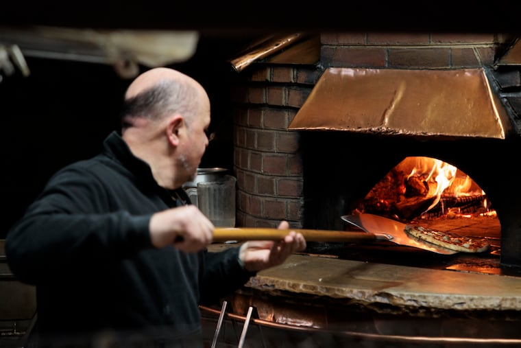 Giuliano Verrecchia making a Margherita pizza at Cafe Michelangelo on Dec. 9.