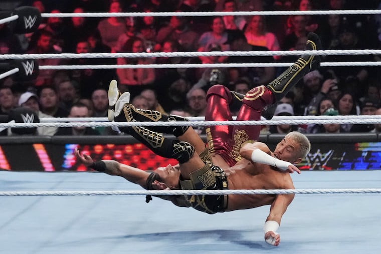 Wrestler Carmelo Hayes tangles with Akira Tozawa, front, during the WWE Monday Night RAW event, March 6, 2023, in Boston. This year's WrestleMania is just days away.