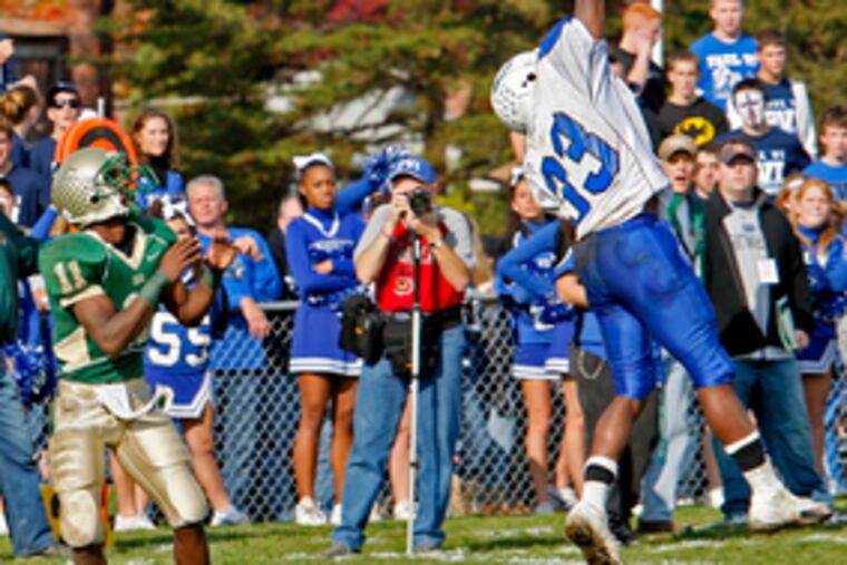Paul VI defender Will Campbell leaps high to tip away a pass intended for Camden Catholic's Dan Famular (left) in the first half. Camden Catholic led by 20-14 at the half and held on for the win.