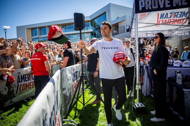 Charlie Kirk hands out hats before speaking at Utah Valley University in Orem, Utah, on Wednesday, Sept. 10.