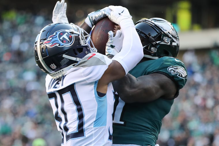 Eagles wide receiver A.J. Brown catches a third quarter touchdown past Tennessee Titans cornerback Tre Avery on Sunday, December 4, 2022 in Philadelphia.