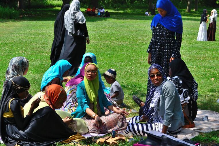 Women gather under a tree for shade at FDR Park during a celebration for the ending of Ramadan on Monday, July 28, 2014. C.F. Sanchez / Staff Photographer
