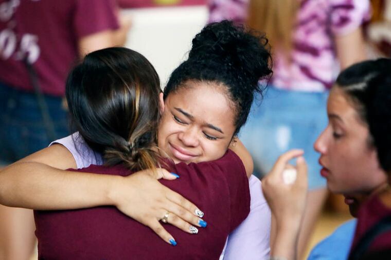 Fellow students from Little Flower High School comfort each other following a prayer service for 17-year-old Jaylin Landaverry on Wednesday July 23, 2014, at Little Flower High School in the Hunting Park section of Philadelphia. Landaverry died Tuesday night at Temple University Hospital from the injuries she suffered during a July 1, 2014, food truck explosion.