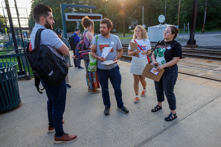 Stephen Bronskill (from left), Nicole Brunet, and Natasha Tabachnikoff distribute information to commuters at the Woodbourne station near Langhorne about SEPTA's funding crisis.