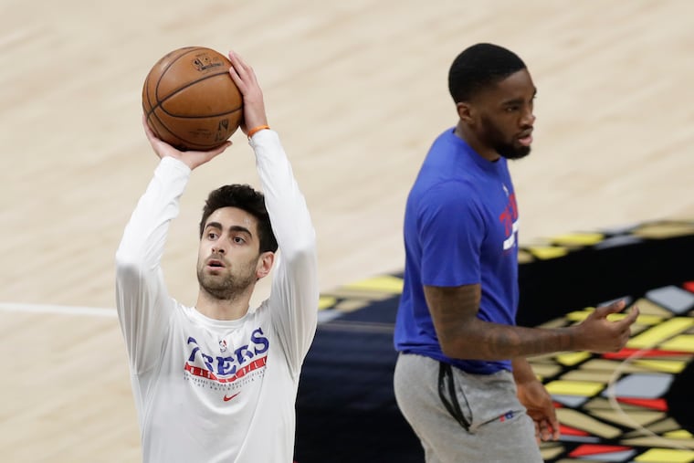 Sixers guard Furkan Korkmaz shoots the basketball as teammate guard Shake Milton walks past during warm-ups before the Sixers play the Atlanta Hawks in Game 4 of the NBA Eastern Conference playoff semifinals on Monday, June 14, 2021 in Atlanta.