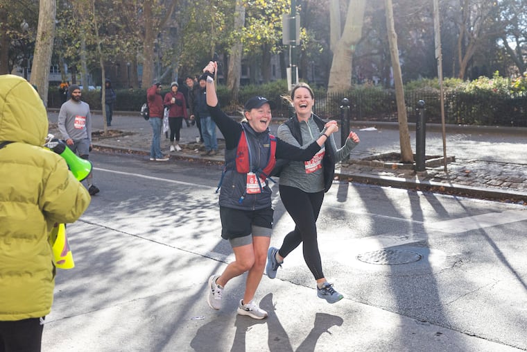 Shelbie Turner (in the cap) and Kara McElvaine got married Saturday, exchanging vows as they ran the Philadelphia Half Marathon.