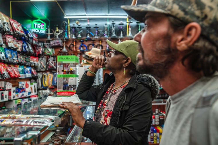 FILE — Customers look over vape products at a store in San Diego, May 31, 2024. After the tobacco company Reynolds American donated $5 million to a super PAC backed by President Trump last month, the F.D.A. issued new guidance that could pave the way for major tobacco companies to begin selling flavored vapes and to snare a chunk of the $6 billion e-cigarette market away from illegal Chinese competitors. (Ariana Drehsler/The New York Times)