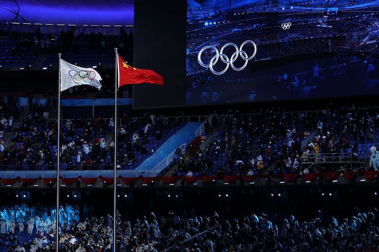 The Olympic (left) and Chinese (right) flags flying next to each other during the Opening Ceremony of the Winter Olympics in Beijing on Feb. 4.