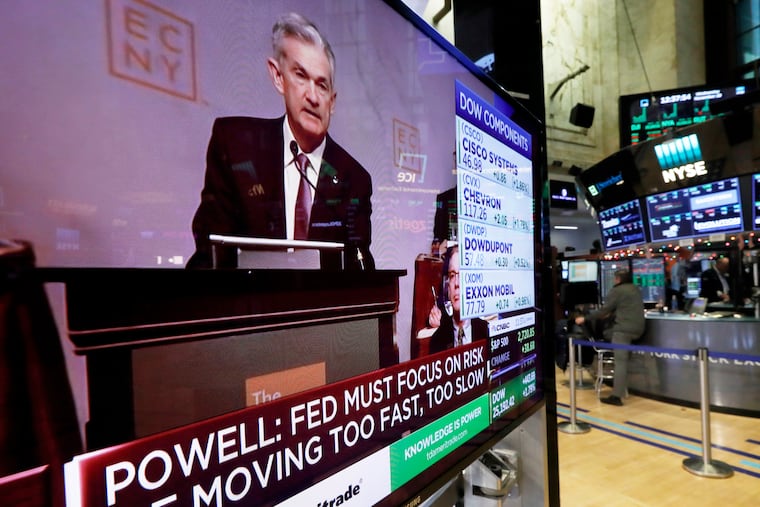 The speech of Federal Reserve Chairman Jerome Powell, to the Economic Club of New York, appears on a television screen on the floor of the New York Stock Exchange, Nov. 28. Powell cast a bright picture of the U.S. economy Wednesday and appeared to suggest that the Fed might consider a pause in its interest rate hikes next year to assess the impact of its credit tightening.