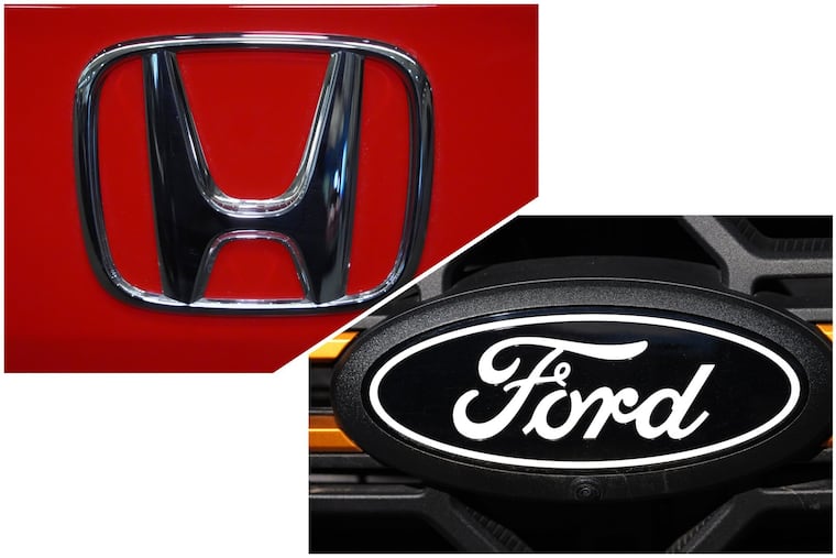 Honda and Ford logos are seen on vehicles.
