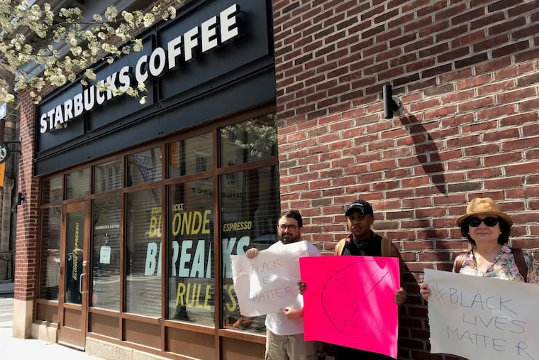 Protesters demonstrate outside the Starbucks at 18th and Spruce Streets.