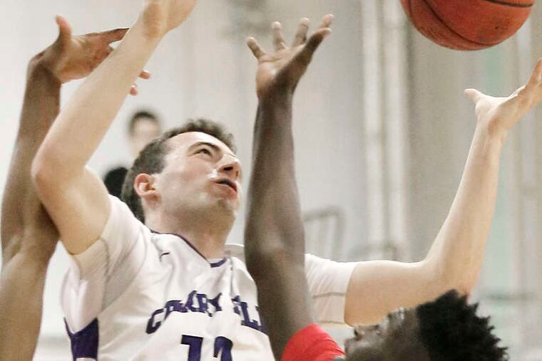 Battling for a rebound are Cherry Hill West's Can Oztamur (12) and Rancocas Valley's Jordan Cole during the first half at Cherry Hill West. ELIZABETH ROBERTSON / Staff Photographer