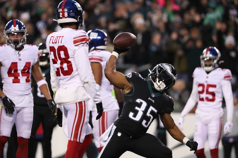 Eagles running back Boston Scott spikes the football after scoring a touchdown against the New York Giants last season.