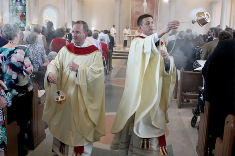 Msgr. Joseph C. McLoone (left), pastor of St. Joseph parish, and the Rev. Brian Kean offer incense during Saturday's dedication rite. (CHARLES FOX / Staff Photographer)