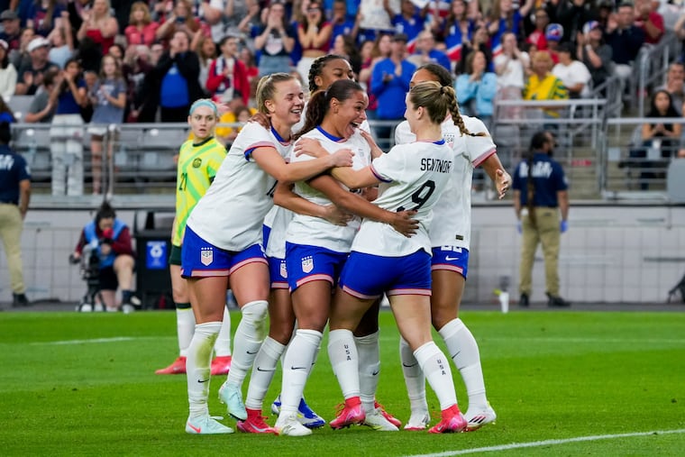Michelle Cooper (center) is congratulated by teammates after scoring her first U.S. national team goal.