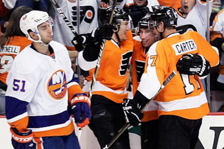 James van Riemsdyk, Andreas Nodl and Jeff Carter celebrate Nodl's goal in the second period. (AP Photo/Tom Mihalek)