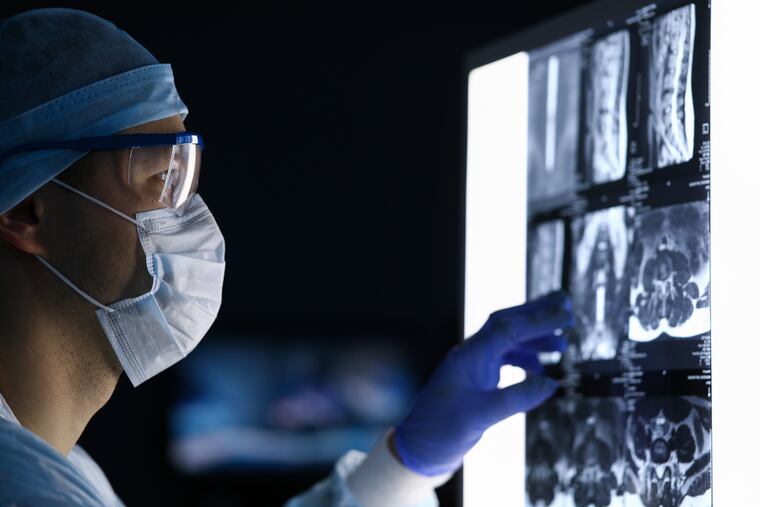 A doctor reviews a patient's MRI.