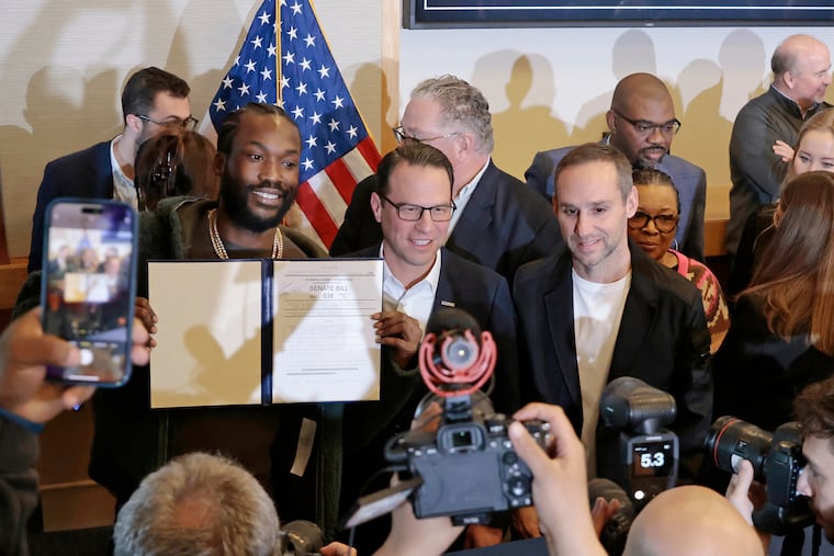Meek Mill, Governor Josh Shapiro and Michael Rubin following the singing of the ceremonial bill celebrating landmark probation reform and clean slate legislation at the National Constitution Center in Philadelphia on Friday, Dec. 15, 2023