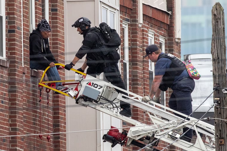 Wilmington Police remove a woman from an apartment house on the 2400 block or North Market Street Thursday morning.
