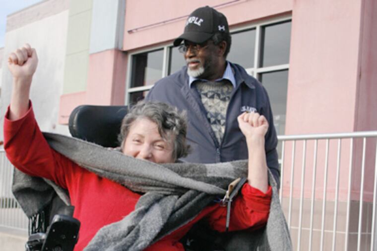 Filomena Ward celebrates her arrival at a theater with the help of Billy Goodman (behind her) of Freedom Cab, which has had five passengers in wheelchairs in the last month. (Ashlee Espinal / Staff Photographer)