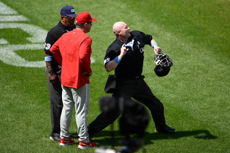Home plate umpire Mike Estabrook, right, ejects Phillies manager Rob Thomson during the sixth inning on Sunday in Baltimore.
