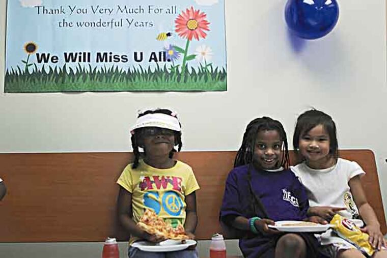 Myla Douglas, Grae Samuels and Hillary Cao (Left to right), students of The Institute for Excellence Charter School, enjoy 'good-bye party' on Wednesday. The school will be shutting on Friday because it was unable to renew its charter. (LUKE RAFFERTY/Staff Photographer)